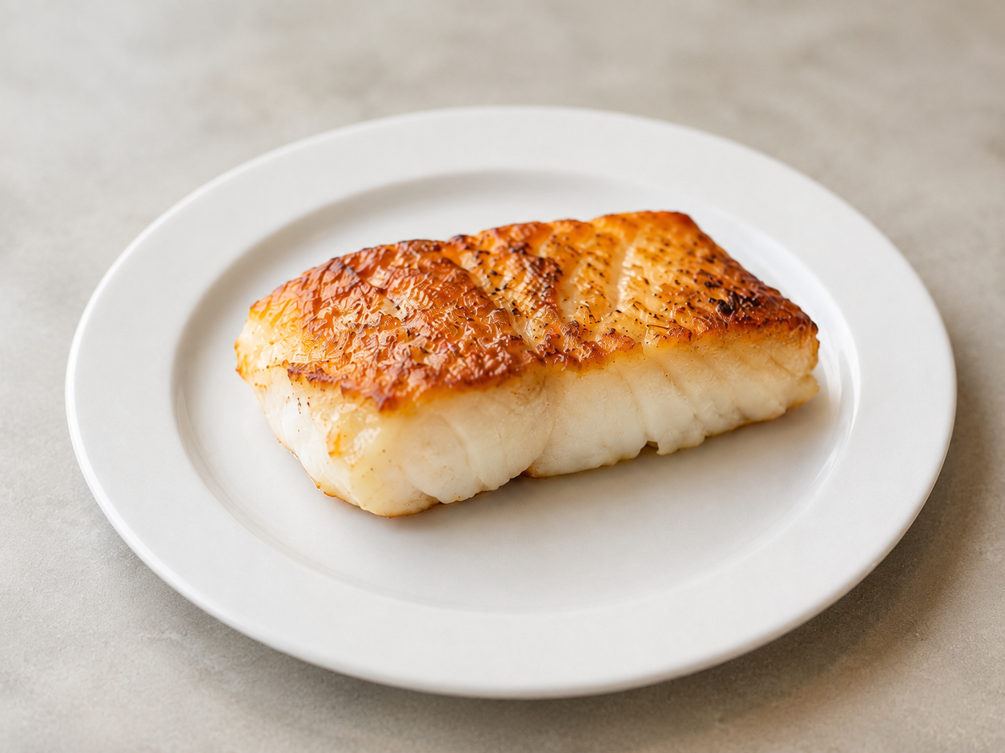 A golden pan-seared cod fillet, flaky inside