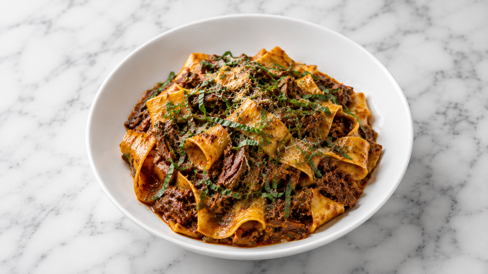 Shredded beef ragu spooned over pappardelle