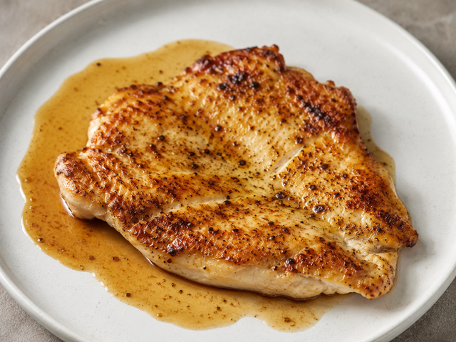 A golden pan-seared chicken breast, seared and rested